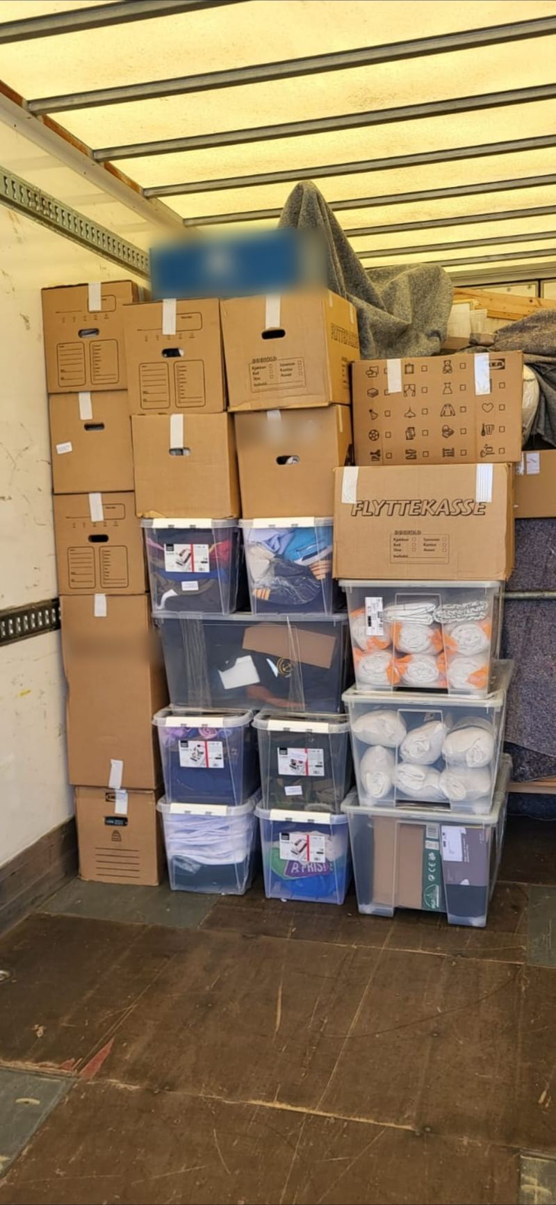 Boxes and storage crates stacked neatly in a removals van