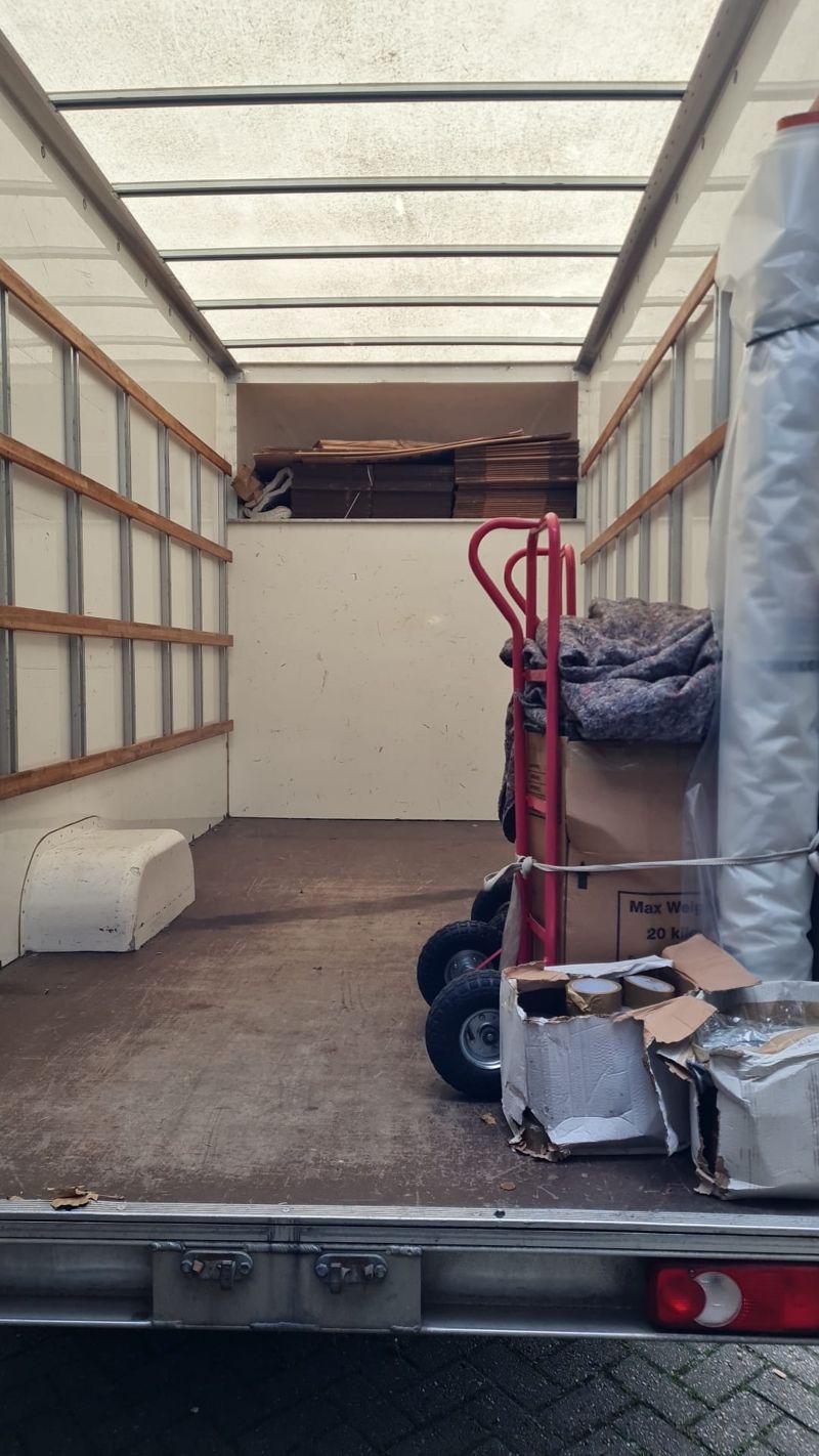 Clean empty Luton van ready for a move, with blankets and trolley